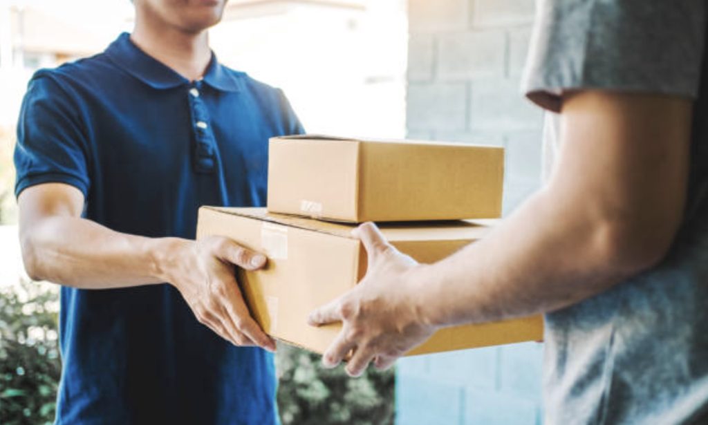 Delivery-guy-handing-parcels-over